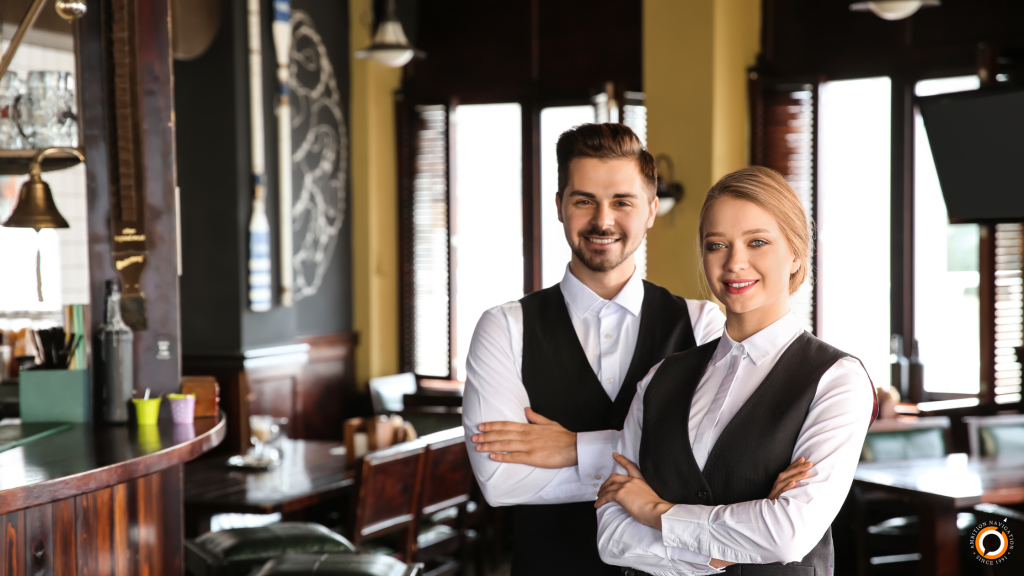 Waiter and waitress in uniforms
